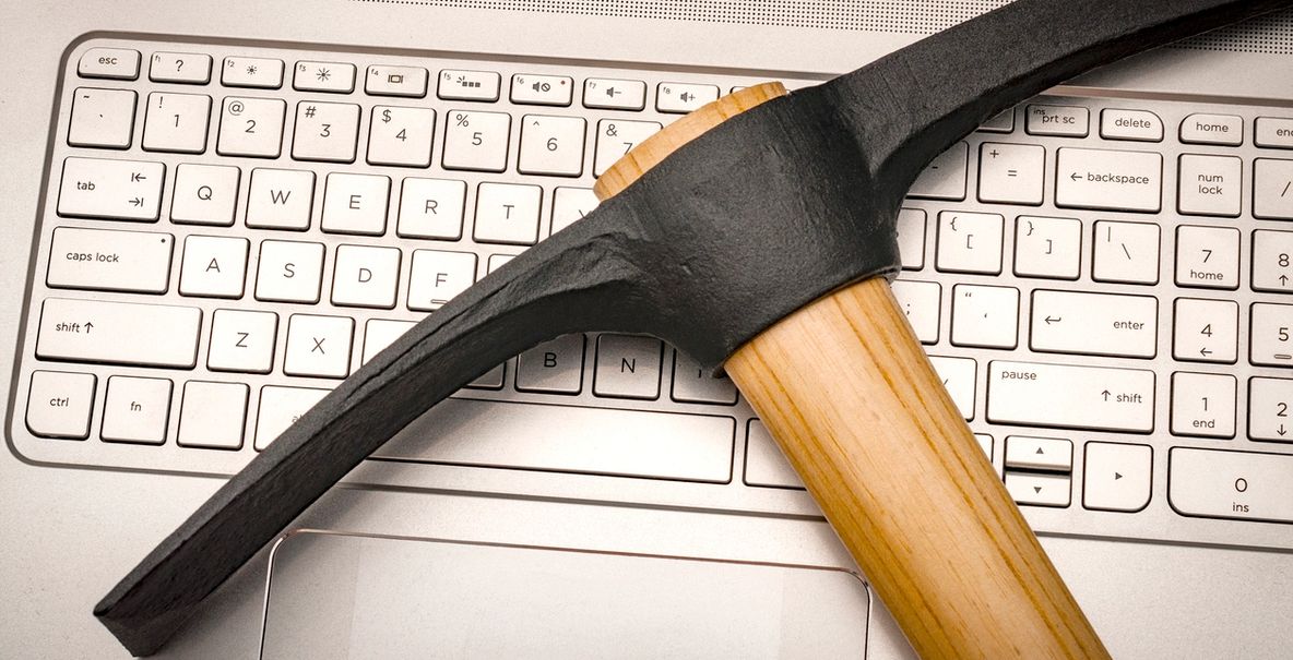 A pickaxe resting across a laptop keyboard